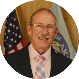 2027 North Dakota Teacher of the Year smiles for photo in Memorial Hall of state Capitol.