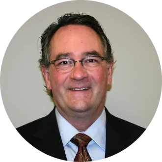 Longtime NDEA/NDU legal counsel Mike Geiermann, in a dark suit and tie