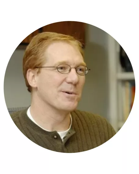 man with red hair and glasses