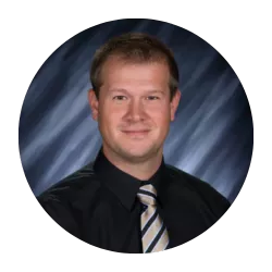 headshot of a man wearing a shirt and tie