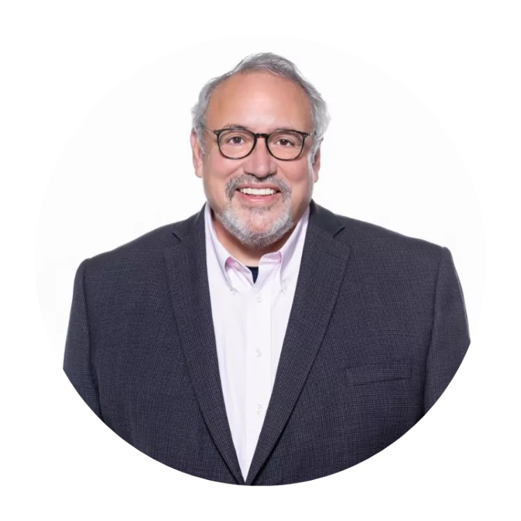man with glasses wearing suit with open collar shirt.