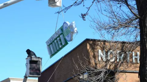 Installation of the North Dakota United name and logo on the NDU headquarters building on Feb. 27, 2014.