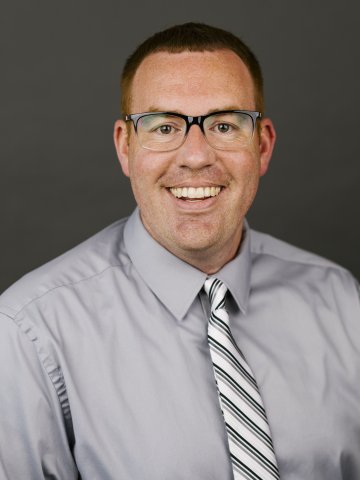 headshot of man wearing glasses